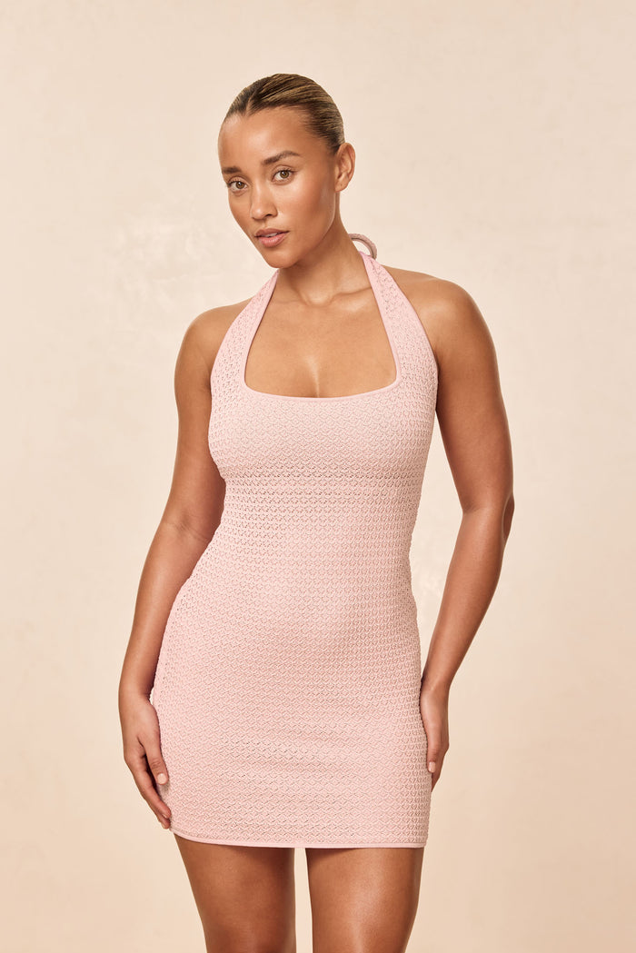 Front of Waikiki Mini Dress in powder pink crochet showing halter neckline and fitted silhouette on beige background