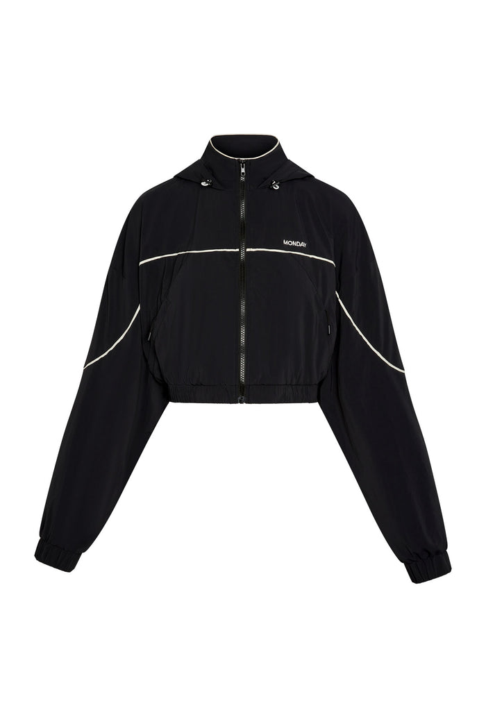 Front view of Westmount Jacket showing cropped fit, zip front, drawstring hood, white piping and MONDAY logo on white background
