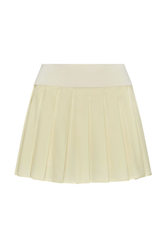 Flat-lay of Wimbledon Skirt in ivory showcasing pleated mini silhouette and wide fitted waistband on white background
