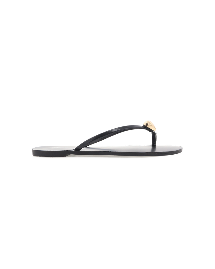 Black flat thong sandal, side view with thin strap and gold teardrop ornament at toe.