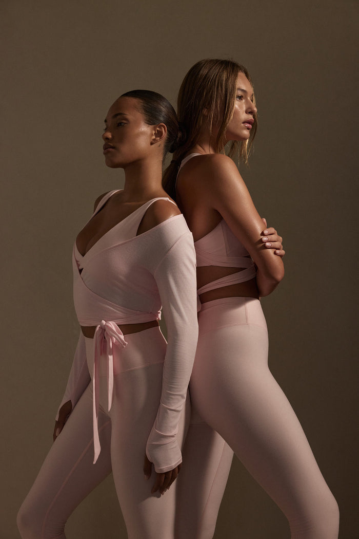 Side view of Yosemite Top in Powder Pink Lightweight Rib showing wrap front, long sleeves with thumbholes and side tie