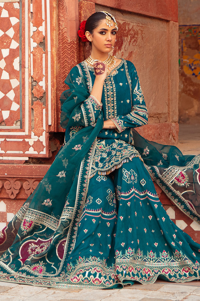 Model in full Zamurd 3PC set: zinc organza shirt, raw‑silk sharara & embellished dupatta styled for festive elegance.