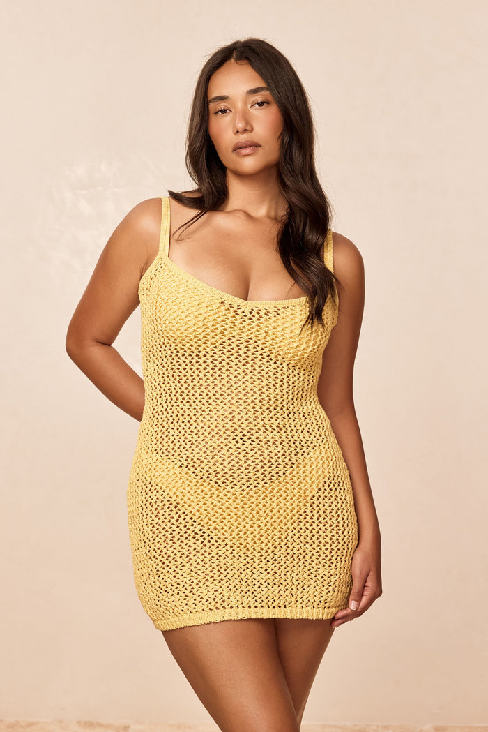 Front view of Zanzibar Mini Dress Meyer Petit Crochet on model, yellow open-knit crochet with slight V neckline on beige background