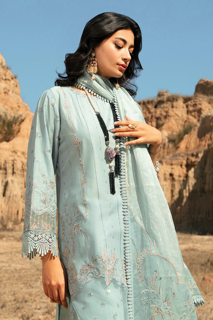 Close portrait showing boat neckline side embroidery and handmade buttons on Zenaria aqua lawn shirt