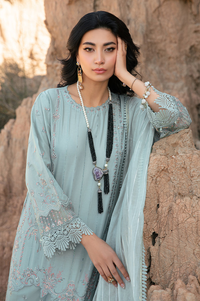 Portrait close up highlighting embroidery sequins and tilla work on aqua ready to wear women suit