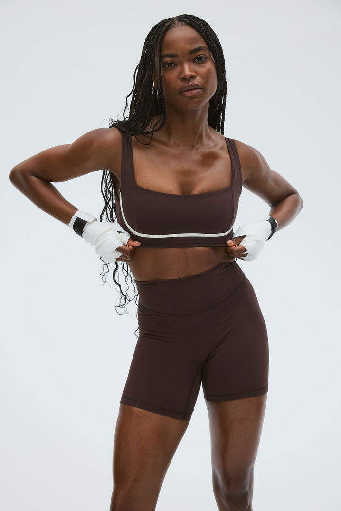 Front view of Zion Bra in Espresso/Ivory showcasing square neckline, wide straps, and ivory piping on gray background