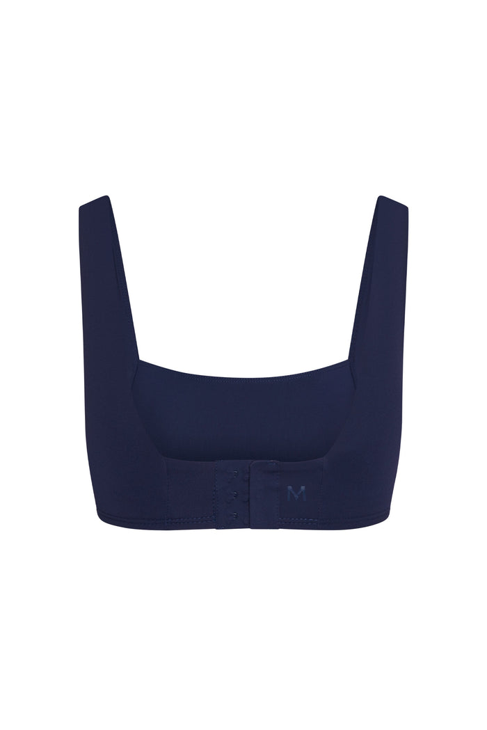Back view of Zion Bra in midnight showing hook-and-eye closure and wide straps on white background