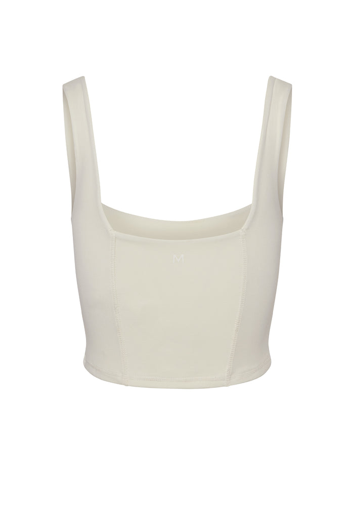 Ivory cropped tank top with square neckline, wide straps and small 'M' logo at center front.