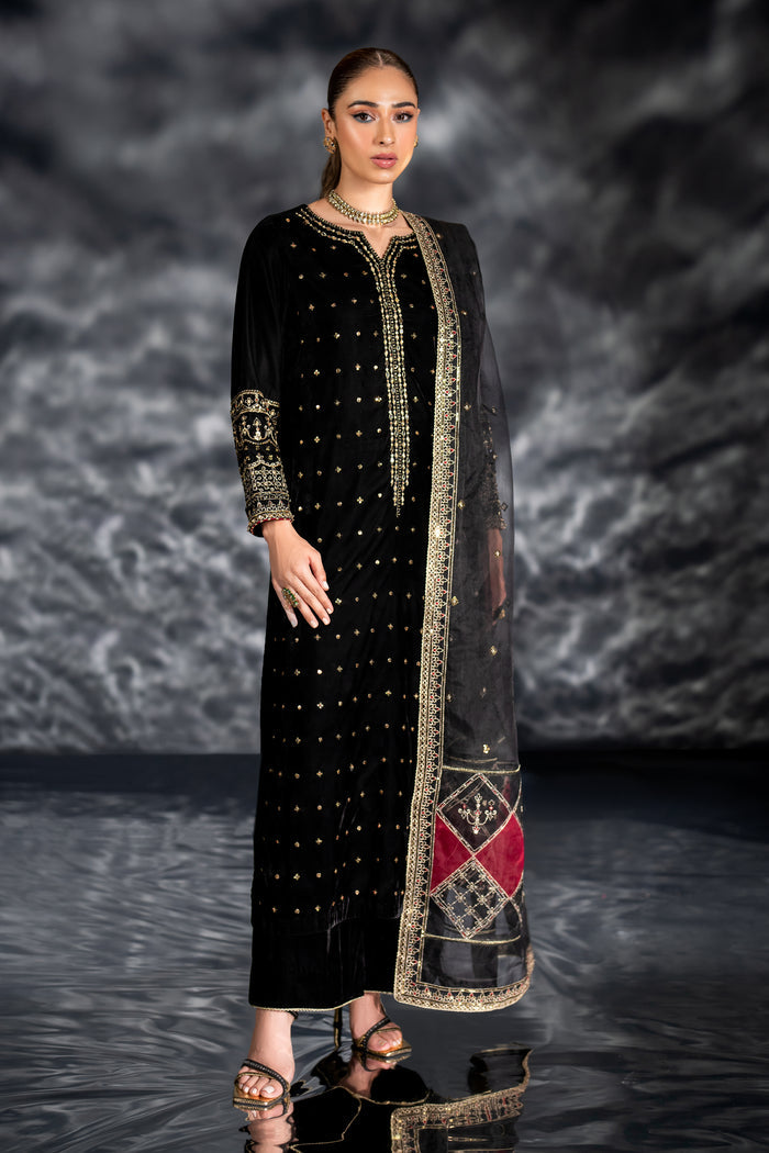 NAQSHI Zuni black velvet long shirt with embellished boat neckline, dense mukeish work, kora dabka mirror embroidery, paired with plain velvet culottes and organza dupatta.