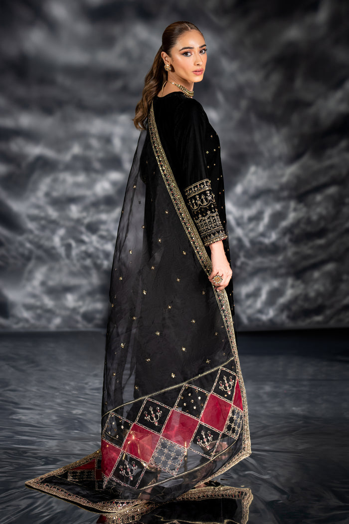 Side view of NAQSHI Zuni showcasing sleek long shirt silhouette, detailed sleeve addon embroidery, crystal taping and velvet culotte trim.